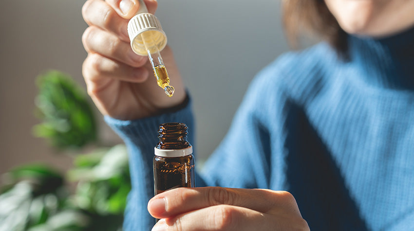 Woman dosing full spectrum CBD tincture and CBD Oil For Sleep